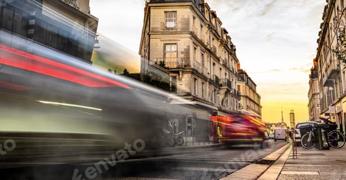 Preview: European street with car trails in the evening.