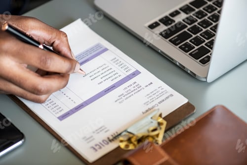 Preview: Closeup of business man checking tax invoice paper