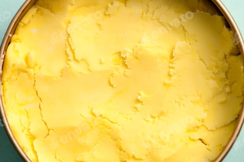Preview: Close-up view of homemade fresh cold natural ice-cream light yellow color in a bowl