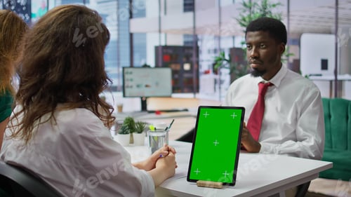 Preview: Interviewer and candidate meeting for an interview next to green screen