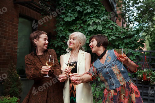 Preview: Friends of middle-aged women celebrate, have fun with sparklers and glasses champagne