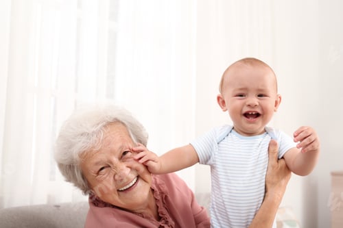 Preview: Happy grandmother with little baby at home