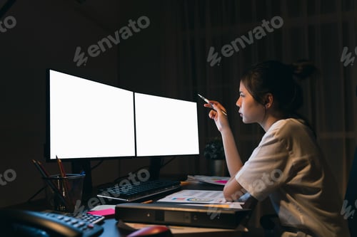 Preview: Stressful Asian business woman sitting on the chair and look at the two computer with blank screen