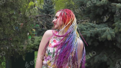 Preview: A girl with a happy smile in a dress with African braids
