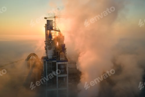 Preview: Aerial view of cement factory with high concrete plant structure and tower crane at industrial