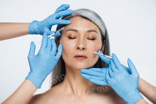 Preview: nude asian woman and doctors in latex gloves holding syringes with beauty injections isolated on