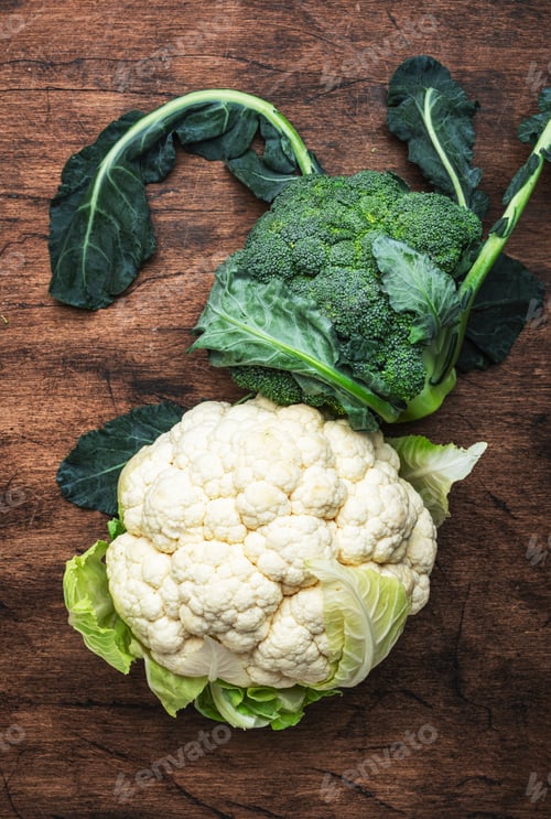 Preview: Autumn food background with cauliflower and broccoli on old rustic wood kitchen table, top view