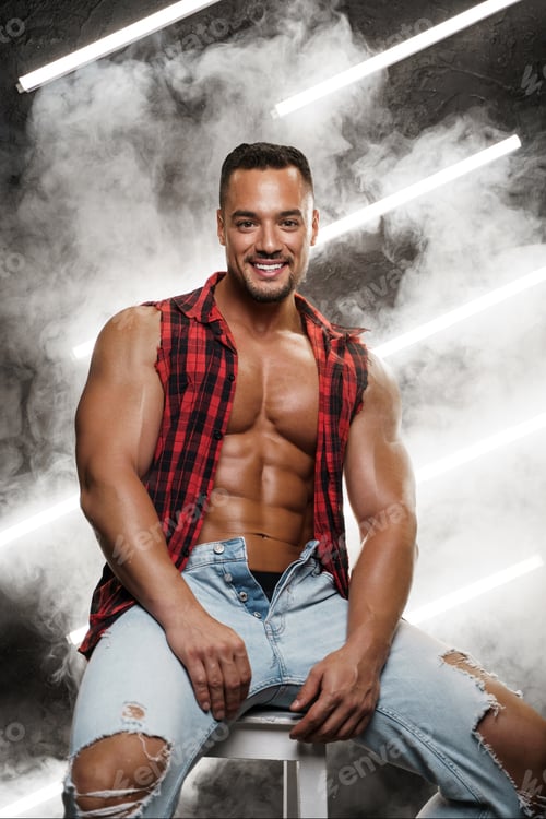 Preview: Shirtless male posing in jeans and plaid shirt against of neon-lit smoke
