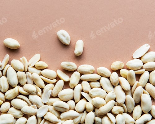 Preview: Peeled peanuts on a brown background