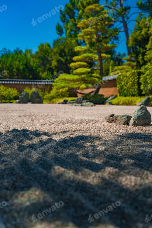 Preview: Tranquil Japanese garden surrounded by large rock formations and trees