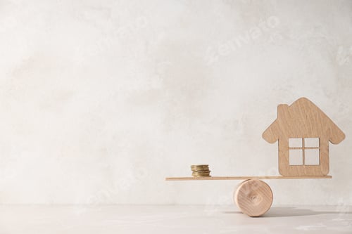 Preview: Toy wooden house on scales with coins