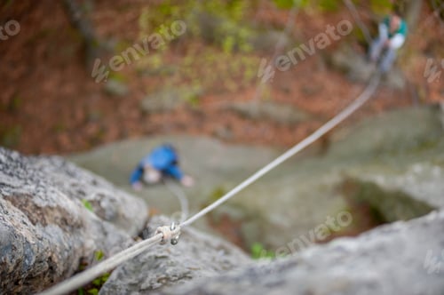 Preview: View hanging of climbers carabiner and rope on the rock