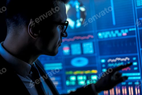 Preview: The man in suit works with data on a blue screen