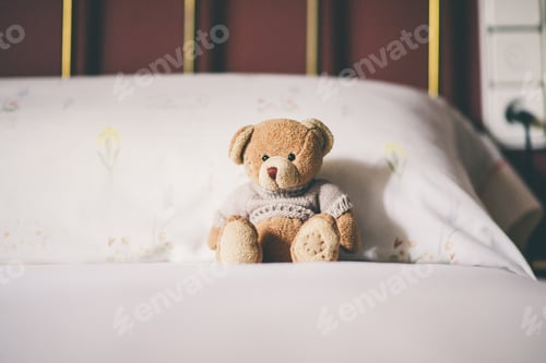 Preview: Teddy bear on the bed, space for text.