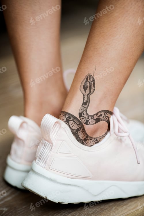 Preview: Closeup of ankle tattoo of a woman