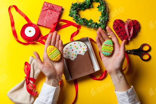 Preview: Female hands are holding Easter cookie