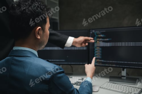 Preview: Group of programmers brainstorm together to write programs on the computer, designing programs to me