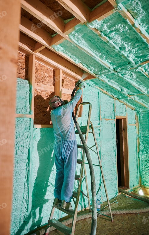 Preview: Worker spraying polyurethane foam for insulating wooden frame house.