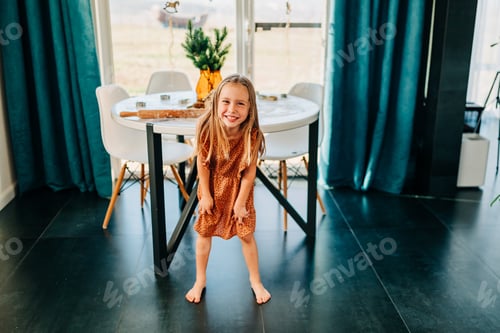 Preview: Little kid happy girl running on the kitchen at cozy home lifestyle authentic moment