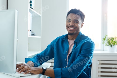 Preview: African designer working on computer
