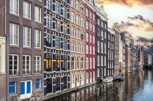 Preview: Amsterdam house, reflection in canal water at dusk. Touristic district Damrak, Netherlands Holland