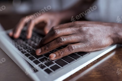 Preview: cropped shot of african-american man typing on laptop