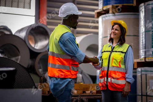 Preview: Team male and female engineers in a metal sheet factory