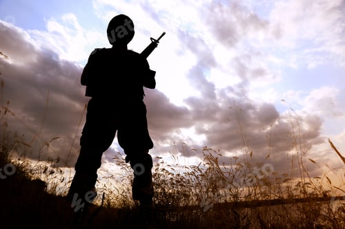 Preview: Soldier with machine gun patrolling outdoors. Military service