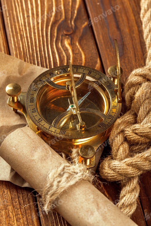 Preview: Compass and rope on wooden table. close up