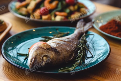 Preview: Fresh fish dorado. Dorado and ingredients for cooking on a table.
