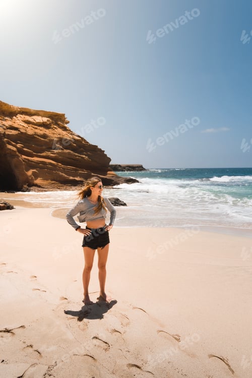 Preview: Young fit Caucasian woman looking at the sea at Playa de los Ojos