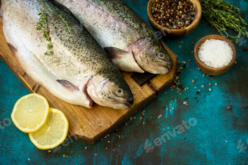 Preview: Fresh Fish. Raw Salmon, Lemon and Spice on a blue slate table.Copy space.