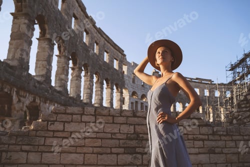 Preview: Beautiful tourist woman visiting the sights in Pula, Croatia. Vacation in Europe at summertime.