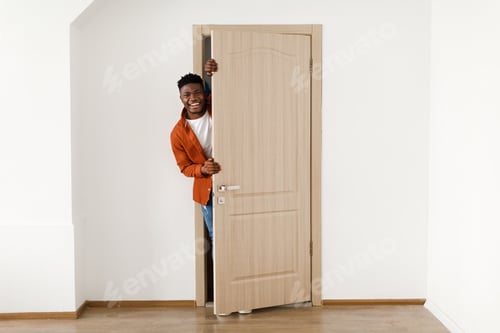 Preview: Happy African American Man Smiling Opening The Door At Home