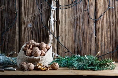 Preview: festive christmas nuts tumbling from a burlap bag