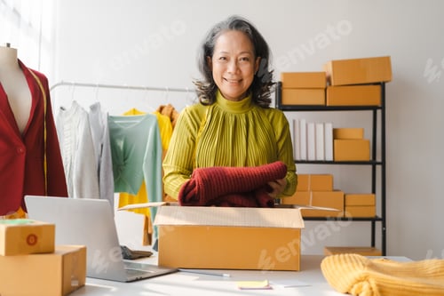 Preview: Elderly Asian business woman home office SME owner of online clothing store. social media influencer