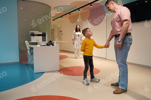 Preview: Middle aged dad with son is waiting for the doctor in the medicine clinic