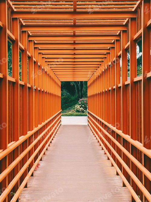 Orange Tunnel Leading to Lush Greenery Outdoors