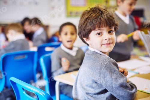 Preview: Young student smiling at the camera during class