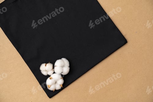 Preview: Textile eco bag and cotton flowers on paper background.