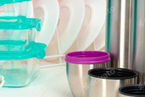 Preview: Thermos bottle against tableware in a kitchen