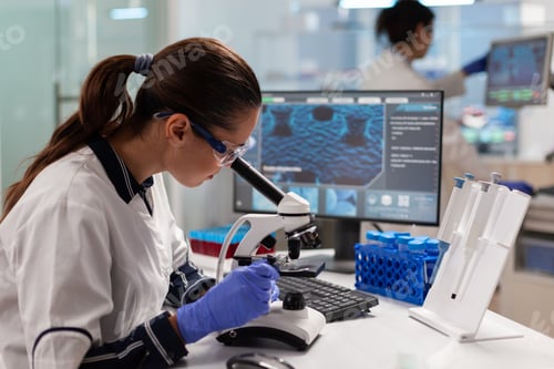Preview: Healthcare scientist researcher vaccine looking at sample through microscope