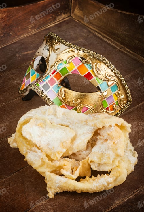 Preview: Fried pastry of italian carnival with venetian mask.
