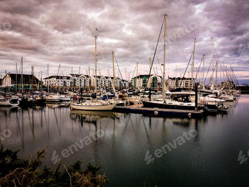 Preview: the sail boats are docked near the resort at dusk,