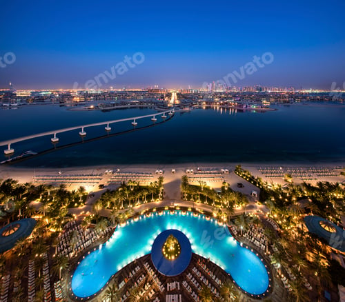 Preview: Cityscape of Dubai, United Arab Emirates at dusk, with bridge from island across the Persian Gulf
