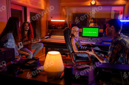 Preview: Multiracial music band recording a new song album inside music studio