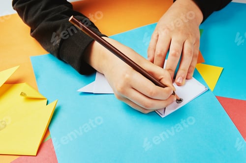 Preview: Boy making paper dog origami