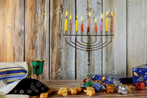 Preview: Hanukkah Candles, Jewish Holidays traditional Candelabra , donuts and wooden dreidels spinning top .