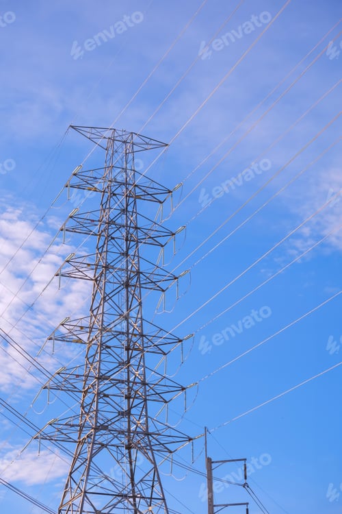 Preview: High voltage electricity pylon against blue sky background in low angle view and vertical frame