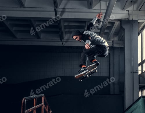 Young skateboarder at skate park indoor